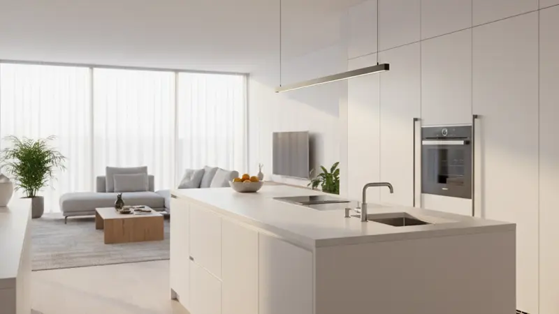 Moderne weiße Hochglanzküche mit grifflosen Fronten und Kücheninsel in einem hellen Wohnraum